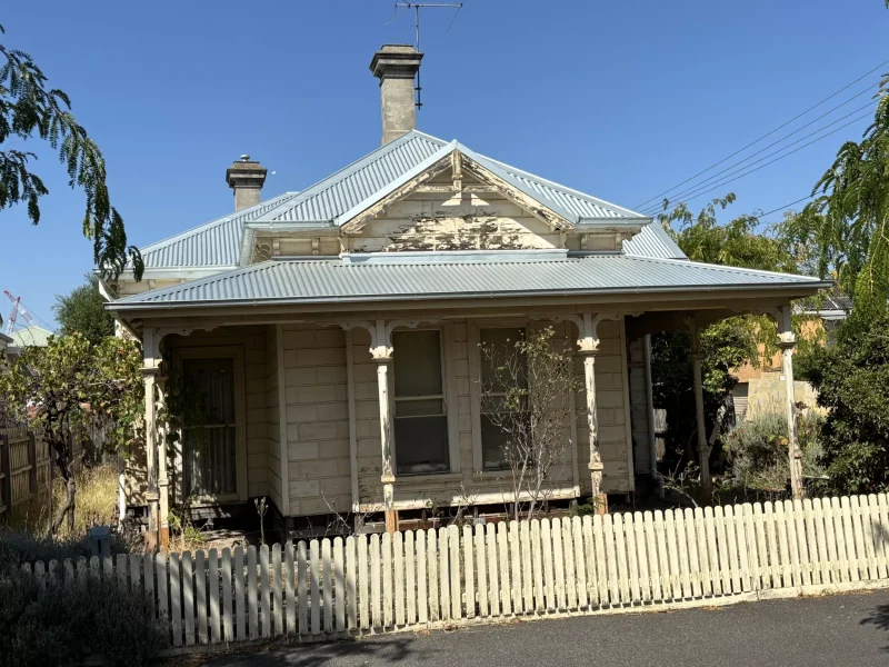 Close-up image of a house in Northcote featuring a newly restored Colorbond roof showcasing a smooth and polished finish.