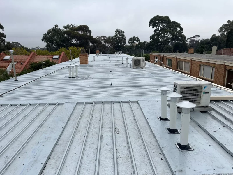 Close-up image of a Colorbond roof in Unit Block Carlton after restoration, showcasing a clean, repaired, and polished surface.